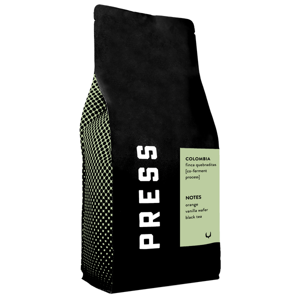 Black coffee bag with 'PRESS' branding and text on a white background