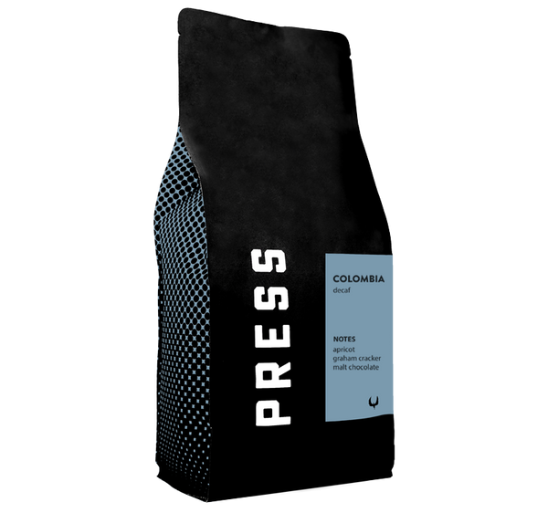 Black coffee bag with 'PRESS' branding and Colombia coffee details on a white background